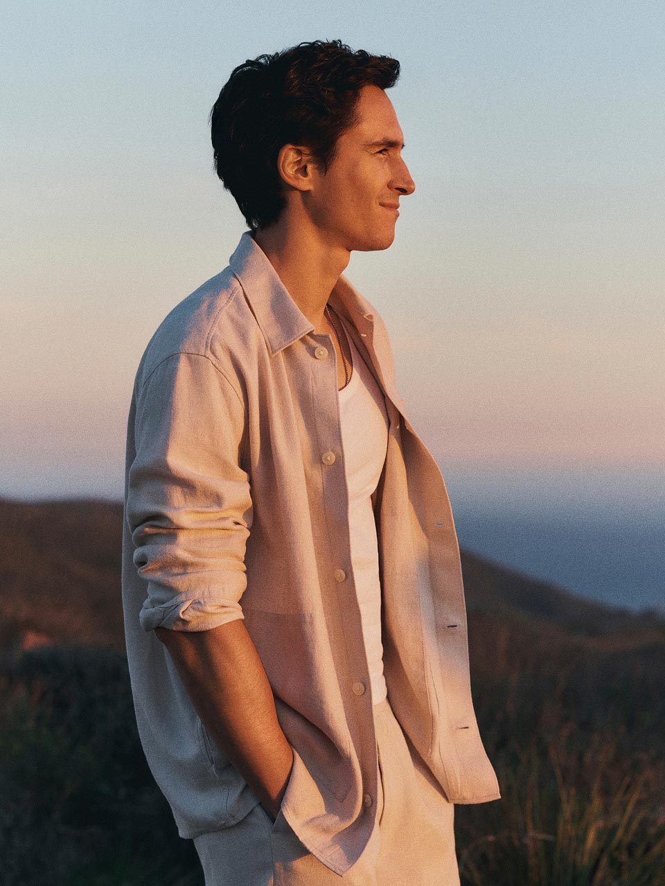 Model posing in an unbuttoned linen shirt